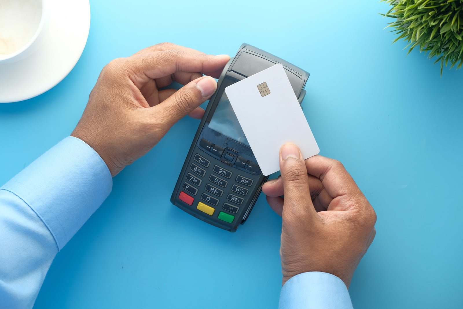 A credit card being presented at a payment terminal